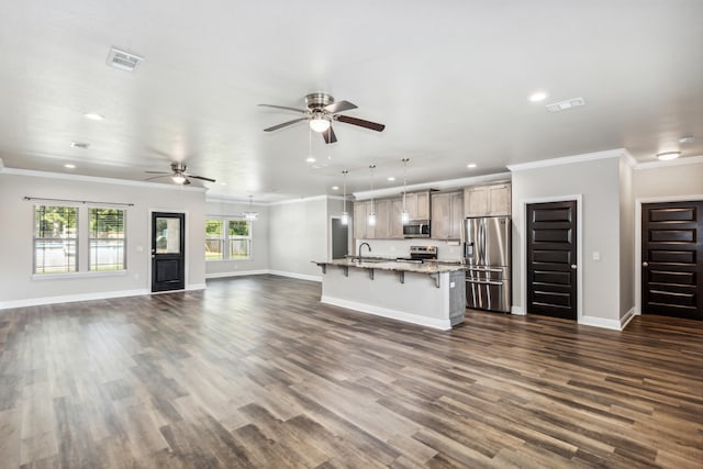 unfurnished living room featuring dark wood-type flooring, crown molding, and sink