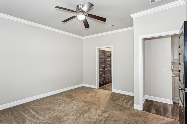 unfurnished bedroom with crown molding, dark colored carpet, and ceiling fan