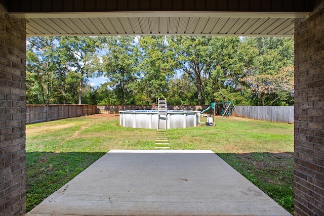 view of yard with a patio and a fenced in pool