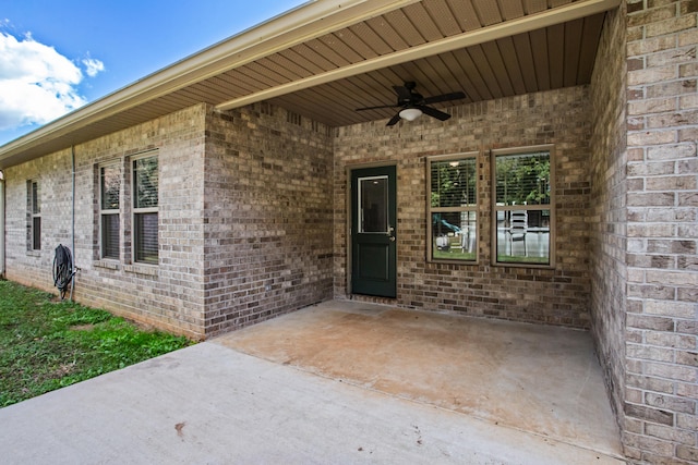 entrance to property featuring a patio area and ceiling fan