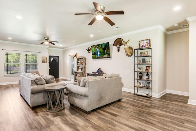 living room with hardwood / wood-style floors, crown molding, and ceiling fan