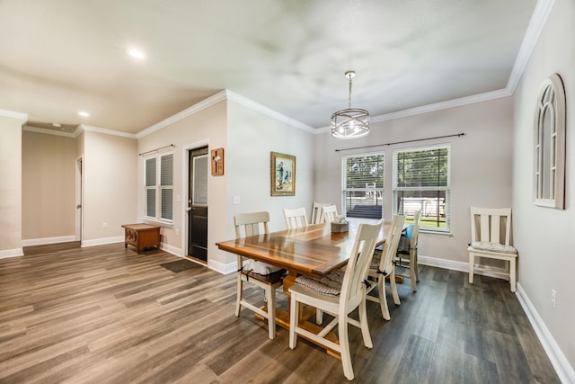 dining area with ornamental molding, a notable chandelier, and dark hardwood / wood-style floors