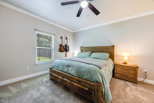 carpeted bedroom featuring ceiling fan and crown molding