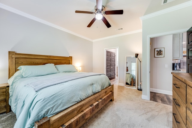 carpeted bedroom with ceiling fan and crown molding