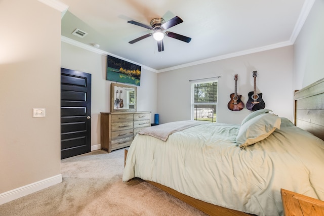 carpeted bedroom featuring ornamental molding and ceiling fan