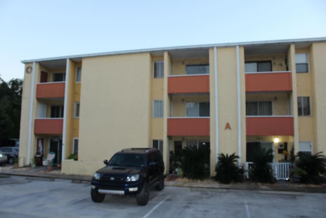 209 W Miracle Strip Pkwy Apt A104, Mary Esther, FL 32569 - view of apartment building / complex featuring uncovered parking