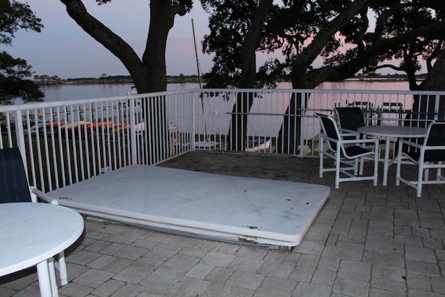 patio terrace at dusk with a water view