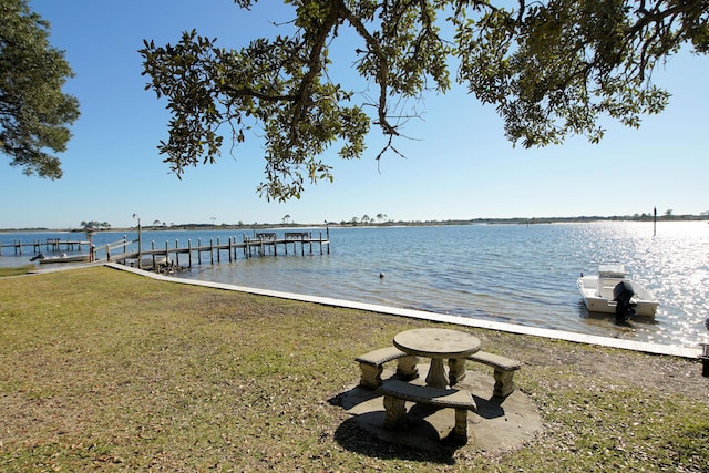 209 W Miracle Strip Pkwy Apt A104, Mary Esther, FL 32569 - dock with a water view and a lawn