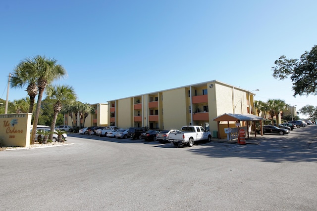 209 W Miracle Strip Pkwy Apt A104, Mary Esther, FL 32569 - view of building exterior featuring uncovered parking