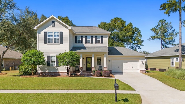 view of front facade with covered porch, a front yard, and a garage