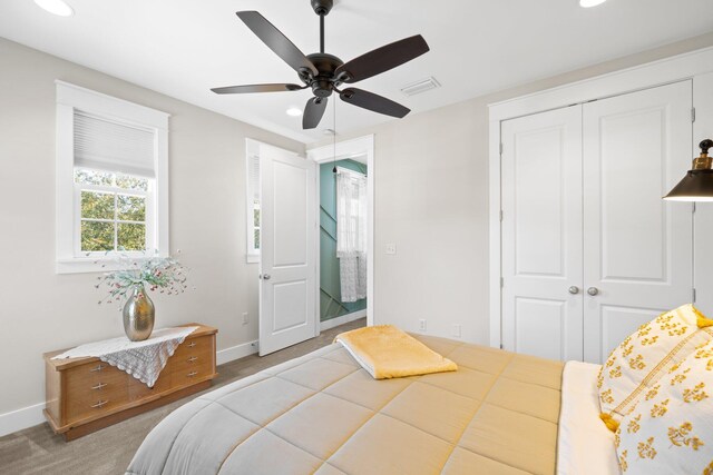 bedroom featuring a closet, ceiling fan, and carpet