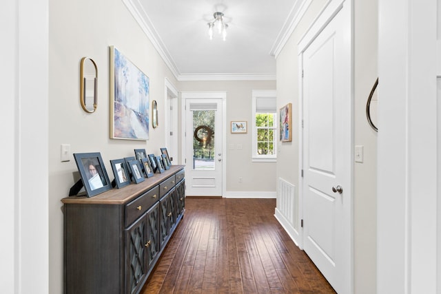 hallway with ornamental molding and dark hardwood / wood-style flooring