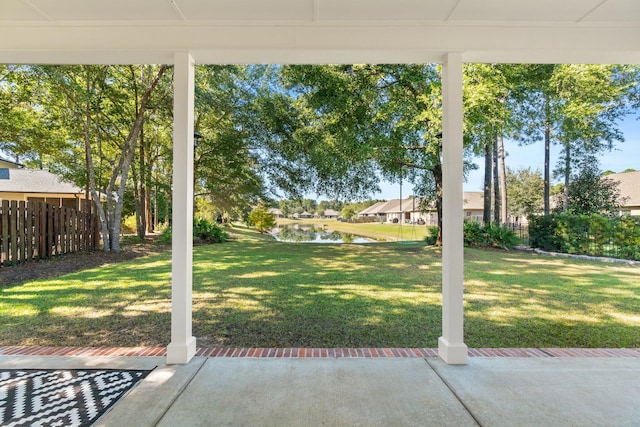 view of yard with a water view and a patio area