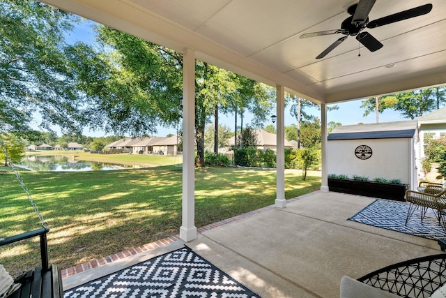 view of patio / terrace featuring a water view and ceiling fan