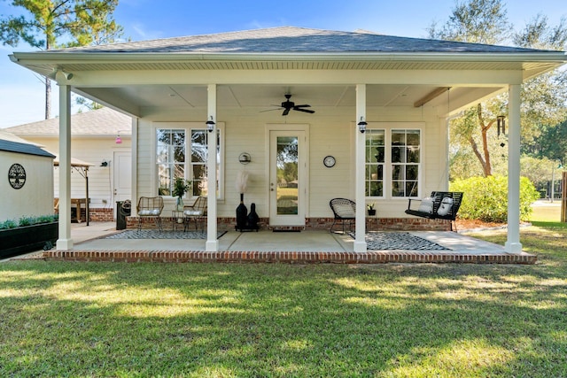 rear view of house featuring a patio, ceiling fan, and a lawn