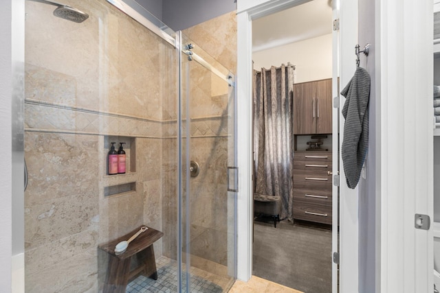 bathroom with tile patterned flooring and an enclosed shower