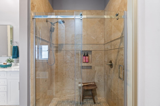 bathroom with a shower with door and vanity