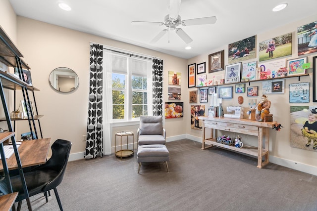 sitting room featuring ceiling fan and dark carpet