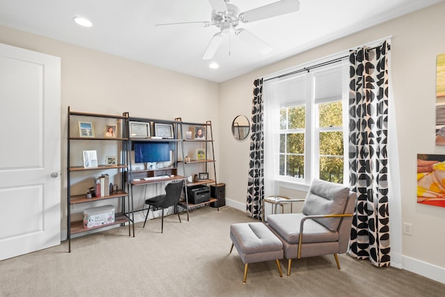 carpeted home office featuring ceiling fan