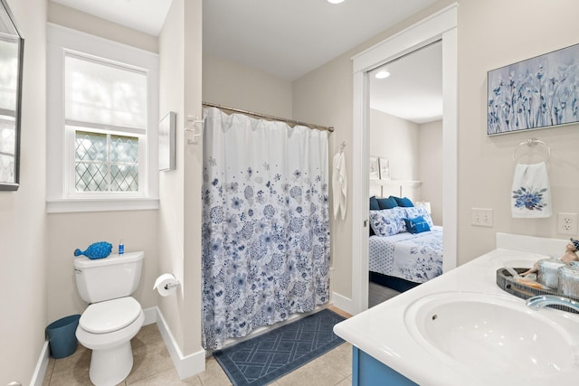 bathroom with vanity, a shower with curtain, toilet, and tile patterned floors