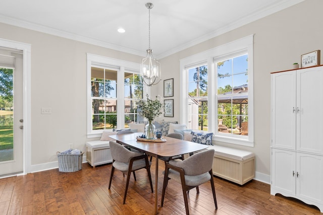 dining area featuring crown molding, dark hardwood / wood-style floors, and a chandelier