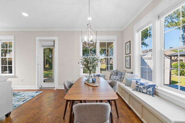 dining room featuring crown molding, an inviting chandelier, and dark hardwood / wood-style flooring