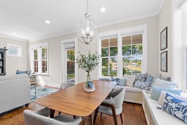 dining area featuring a notable chandelier, ornamental molding, and dark hardwood / wood-style floors