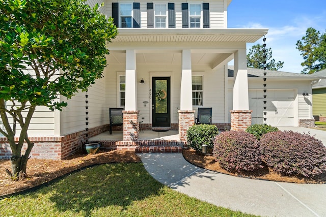 entrance to property with a porch and a garage