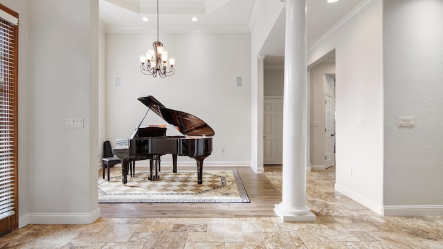 misc room with a chandelier, decorative columns, and ornamental molding