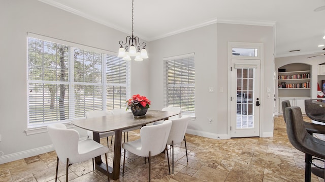 dining area featuring built in shelves, a wealth of natural light, and ornamental molding