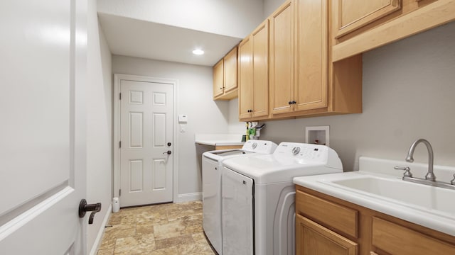 laundry room featuring cabinets, washer and dryer, and sink