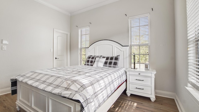 bedroom with dark hardwood / wood-style floors, multiple windows, and crown molding