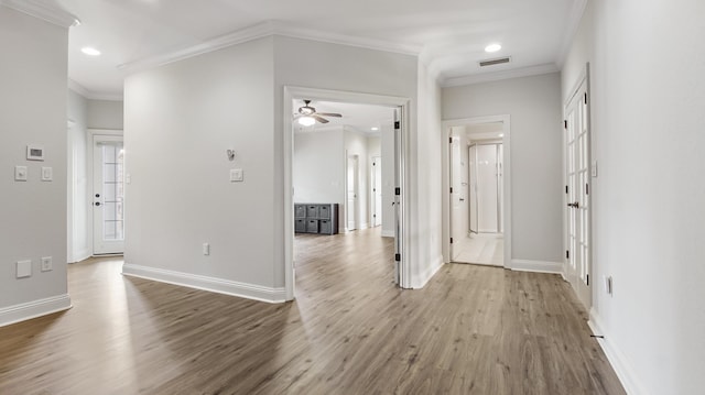 interior space with wood-type flooring and ornamental molding