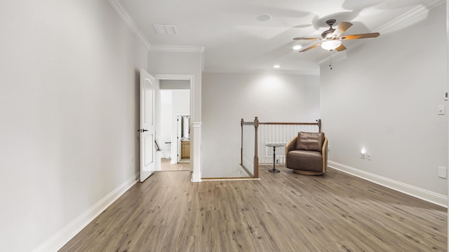 unfurnished room with hardwood / wood-style flooring, ceiling fan, and ornamental molding