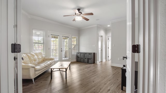 living room with hardwood / wood-style floors, ceiling fan, crown molding, and french doors