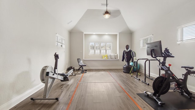 workout area with high vaulted ceiling and hardwood / wood-style flooring