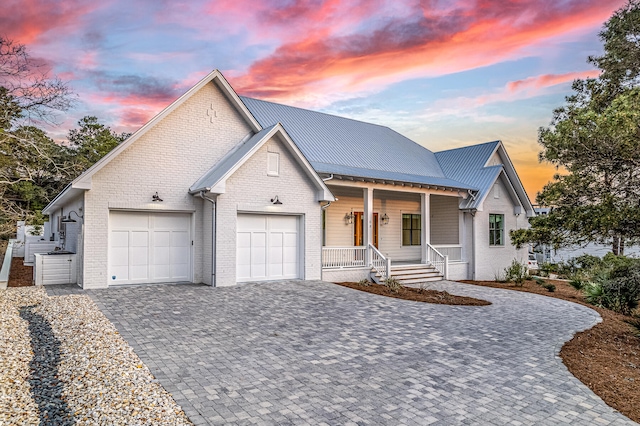 view of front of house with covered porch and a garage