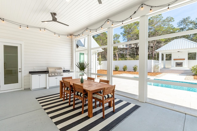 sunroom with wooden ceiling and ceiling fan