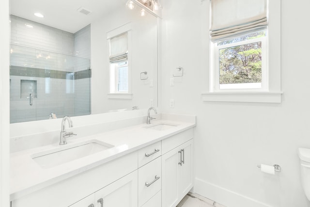 bathroom with vanity, an enclosed shower, and toilet