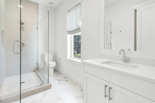 bathroom with vanity, a shower with shower door, and toilet