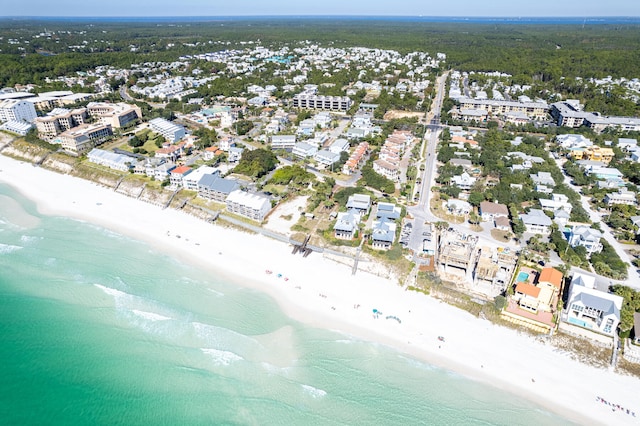 birds eye view of property with a water view and a beach view