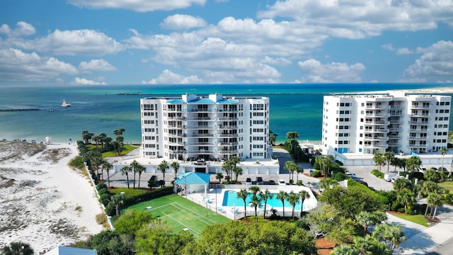 bird's eye view featuring a water view and a beach view