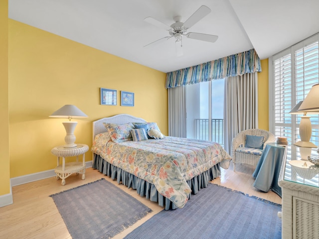 bedroom featuring ceiling fan, wood finished floors, and baseboards