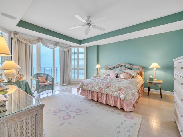 bedroom with access to exterior, visible vents, ceiling fan, wood finished floors, and baseboards