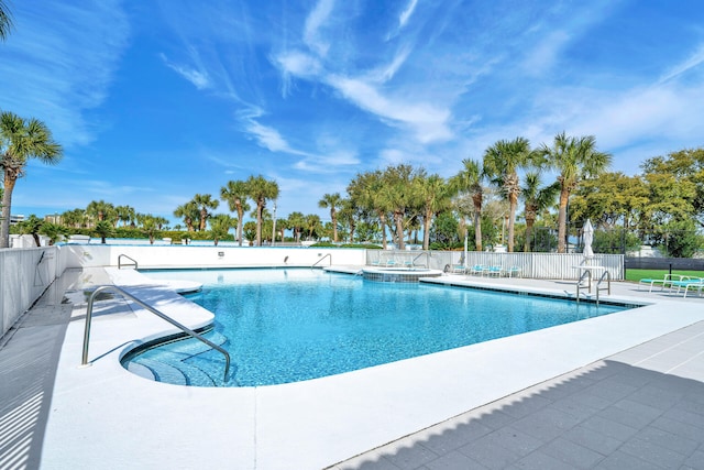 community pool featuring a patio area and fence