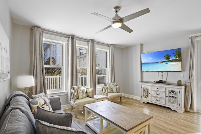 living room featuring light hardwood / wood-style flooring and ceiling fan