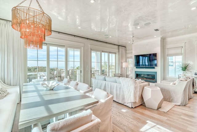 living room featuring light hardwood / wood-style floors and a notable chandelier