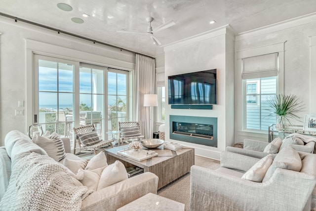 living room with crown molding and ceiling fan