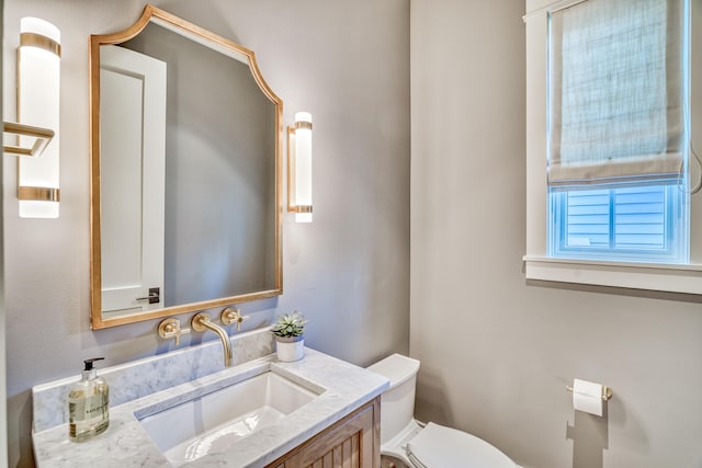 bathroom featuring vanity and toilet