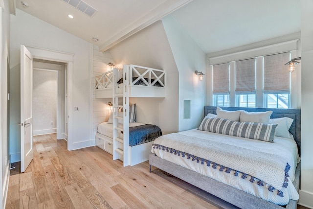 bedroom featuring vaulted ceiling and light wood-type flooring